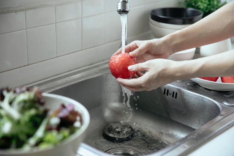 pomidor pod strumieniem wody w kuchni